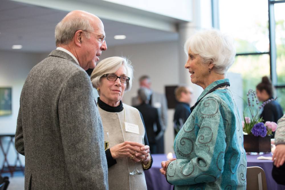 Three people speaking to each other at the event.